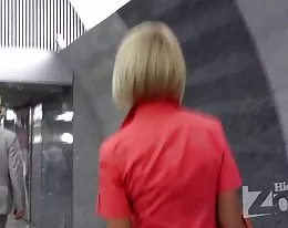 Tanned blonde in a short red dress.