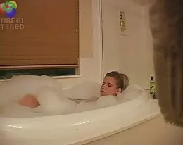 Sexy blond girl caught playing with herself in the bath