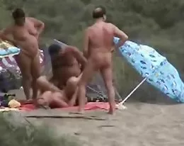 Two mature couples having fun at nude beach