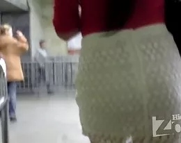 Tanned babe in white knit skirt.